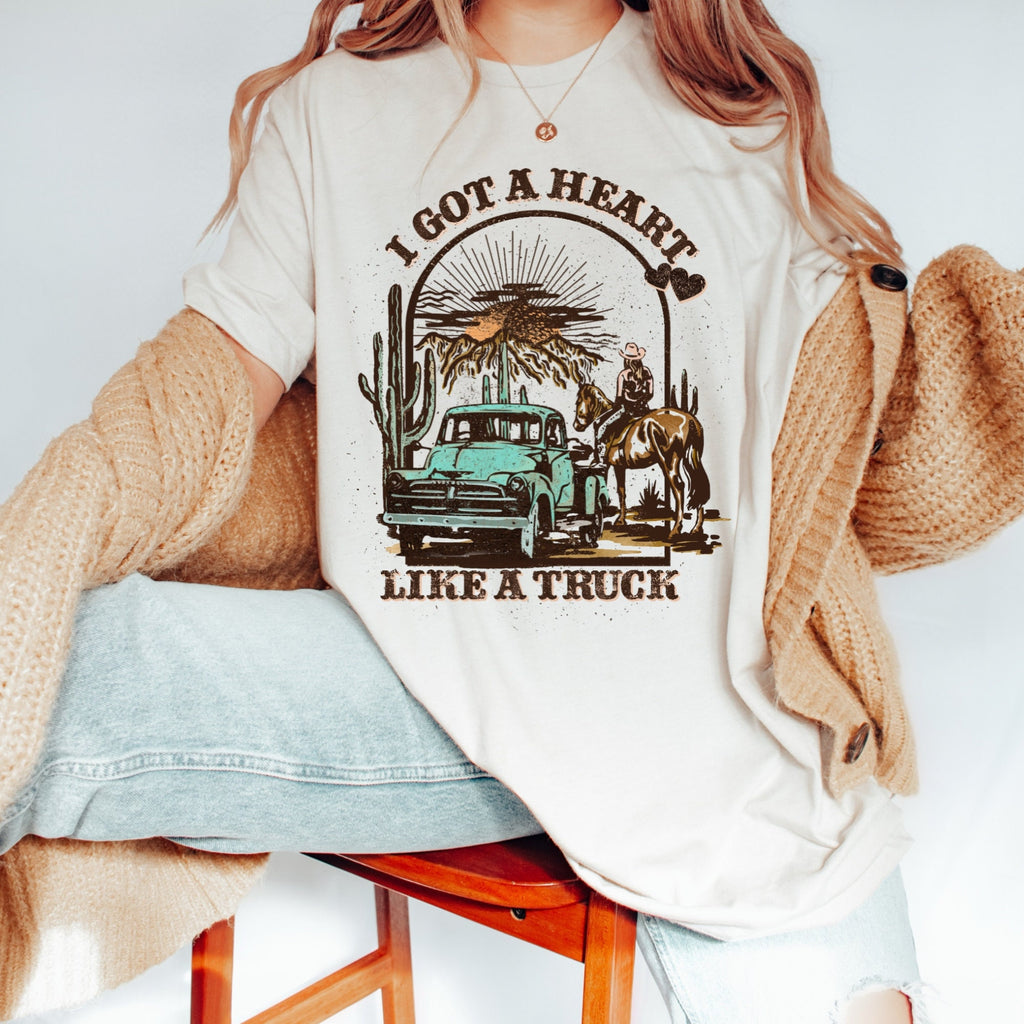 Women's "I Got A Heart Like A Truck" Unisex Fit Jersey Short Sleeve Tee In The Color Soft Cream, Lainey Wilson